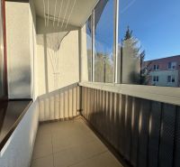 A loggia with glazing and a view of the surroundings in a 4-room apartment.