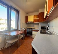 A kitchen in a 4-room apartment with tiles and a kitchenette.
