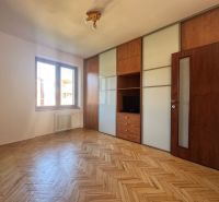 A room with a built-in wardrobe and a wooden decor floor in a 4-room apartment.