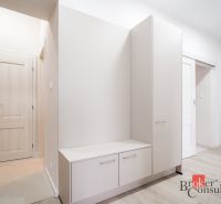 Entrance hall with white furniture in a 3-room apartment, floor with wood decor.