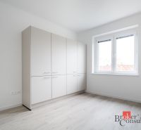 A bright room with a white wardrobe and a wood-patterned floor in a 3-room apartment.