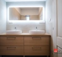 A bathroom with a cabinet with two sinks in a 3-room apartment, backlit mirror.
