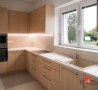A kitchen in a 3-room apartment with wooden decor and modern appliances.