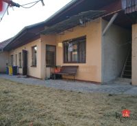 A family house in Ladice with an entrance terrace and dry grass in the garden.