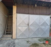 Metal garage door next to the staircase on the property of a family house in Ladice.
