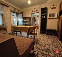 Living room with carpets and wooden furniture in a family house.