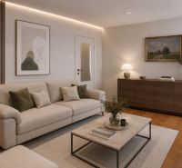 Living room with a sofa and a table in a 2-room apartment with a wooden decor floor.
