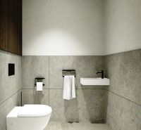 Bathroom in a three-room apartment with stone walls and a wall-mounted toilet.