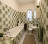 Bathroom in a family house with ceramic tiles and a bathtub in green shades.