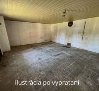 An empty room in a family house with old tiles and white walls.