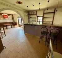 Bar counter and seating in the interior of a family house with tiling.