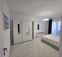 Bright bedroom in a 2-room apartment with modern furniture and ceramic flooring.