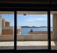 View from a 3-room apartment in SRIMA of the sea through a large French window.