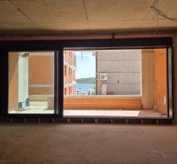 Sea view through a large window in a 3-room apartment in the city of Srima.