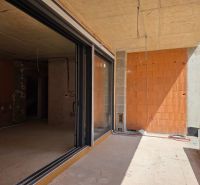 Unfinished 3-room apartment in SRIMA with glass sliding doors and bare brick walls.