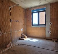 Unfinished room in a 3-room apartment with exposed brick walls and a window.