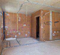 Construction of a 3-room apartment with brick walls and installation of utilities.