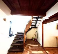 The interior of the cabin with a wooden staircase and a floor with a wooden decor.