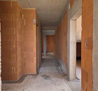 Shell construction of a 4-room apartment with brick walls and a concrete ceiling.