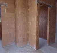 Interior of a 4-room apartment, unplastered brick walls with door openings.