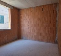 Unfinished room with brick walls, part of a 4-room apartment.