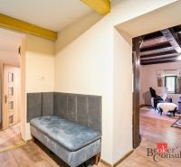 A cottage with cozy seating, a floor with a wooden decor, a view of a comfortable living room.