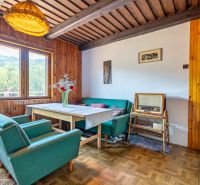 Interior of a cabin with retro furniture and a wooden decor floor, comfortable armchairs, vintage radio.