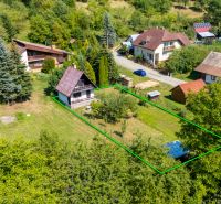 The house on Dubkova Street in Lazy pod Makytou is surrounded by greenery and other houses.