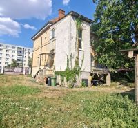 A family house on Levická Street in Vráble with abundant greenery and a brick roof.