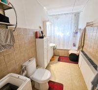 Bathroom with a bathtub and toilet in a family house.