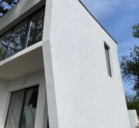 A cottage in Šahy with prominent glazing and a white facade.