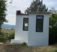 A small cottage in Šahy, surrounded by trees and beautiful nature.