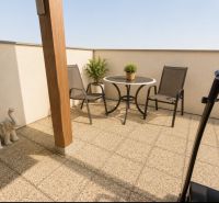 Terrace of a 1-bedroom apartment with a view from Čerešňová Street, Chorvátsky Grob, and garden furniture.
