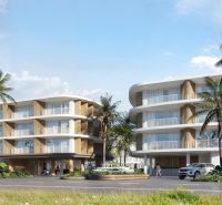 Construction of apartments in Surat Thani with palm trees and modern architecture.