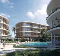 Apartment construction in Surat Thani with rounded buildings and a pool in the middle of the complex.