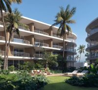 Apartment buildings in Surat Thani: apartment buildings with palm trees and greenery in the background.