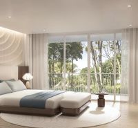 Bright bedroom in a 2-room apartment with large windows and a wooden decor floor.