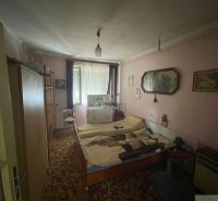A room in a family house with a carpet, decorations, and antique furniture.
