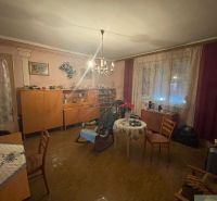 Living room in a family house with furniture, curtains, and a wooden decor floor.