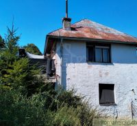 A family house in Stará Turá with a worn-out roof and overgrown surroundings.