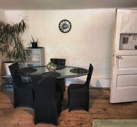 Dining area in a family house with wooden flooring and a glass table.