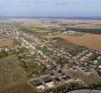 Aerial view of agricultural and forest land in Križovany nad Dudváhom with the village.