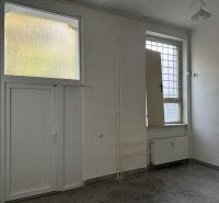 White walls and glass doors create bright offices.