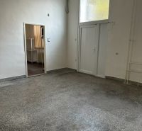 An office interior with white walls and a floor with a concrete effect decor.