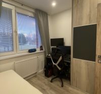 A room in a 3-room apartment with a desk, a wardrobe, and a window with blinds.