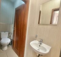 A restroom with a sink and a mirror in commercial premises.