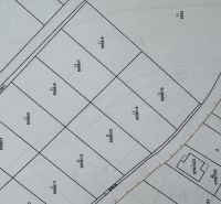 Map of residential plots in the village of Mlynica, showing parcel numbers and arrangement of plots.