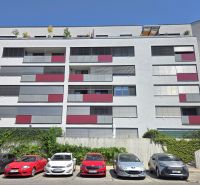 Apartment building on Malokrasňanská Street in Bratislava - Rača with parked cars in front.