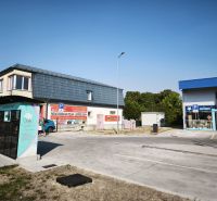 Commercial premises on SNP Street in Šaľa with parking lot and advertising signs.