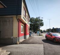 Commercial premises on SNP Street in Šaľa with a red car on the road.